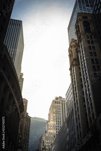 Low Angle View of urban Scene in Manhattan with ancient and modern Skyscrapers - Copy Space © christianthiel.net