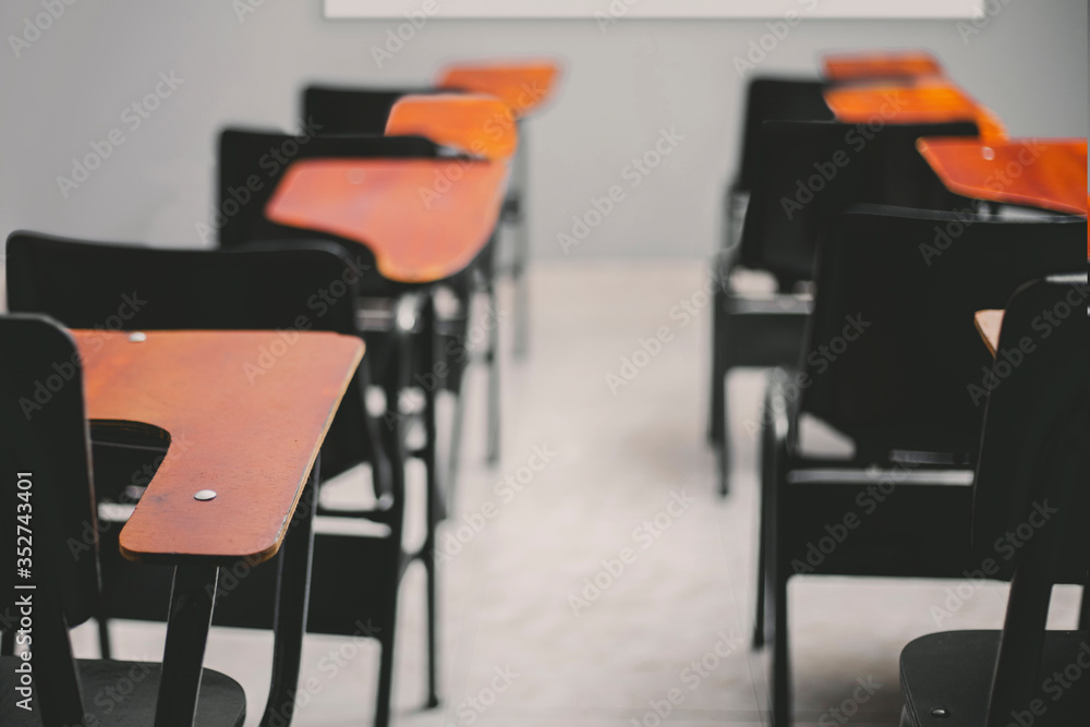 close-up of empty desks in classroom, concept social distancing close-up of empty desks in classroom, concept social distancing