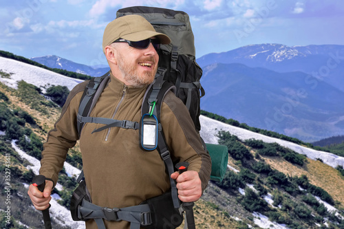 Happy tourist with backpack is traveling in the highlands