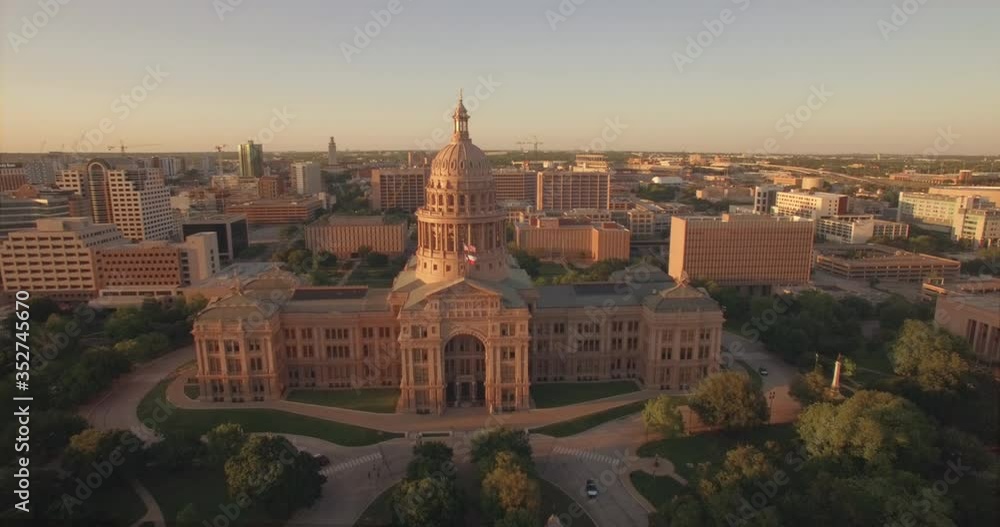 The Texas State Capitol, its empty lawn, and the surrounding Austin buildings at sunset during the covid coronavirus pandemic and shutdown The Texas State Capitol, its empty lawn, and the surrounding Austin buildings at sunset during the covid coronavirus pandemic and shutdown