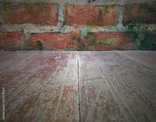 Background of light wooden floor and grungy texture brown brick wall  blank horizontal space