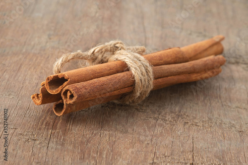 Top view cinnamon sticks isolated on wooden table background.