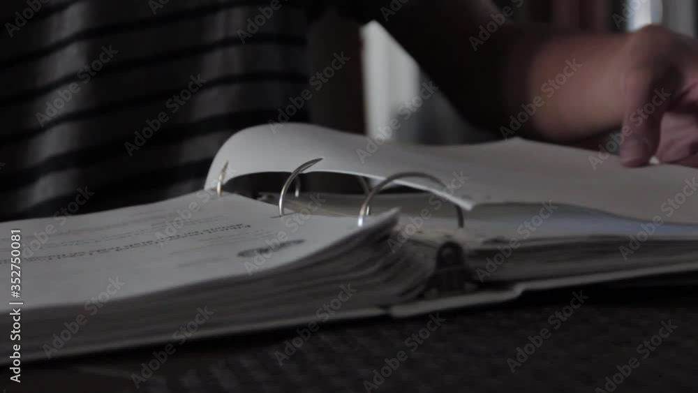Boy flips page in study school folder report Boy flips page in study school folder report