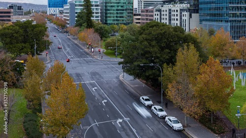 Late afternoon city rush hour time lapse overlooking a busy intersection and adjacent park lands, Adelaide, South Australia photo