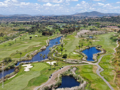 Aerial view of a green golf course during sunny day in South California. USA