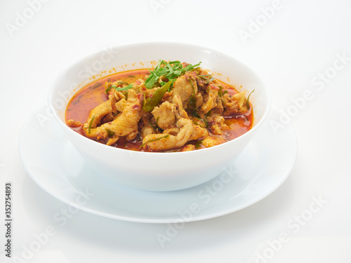 Panang chicken curry in white bowl.