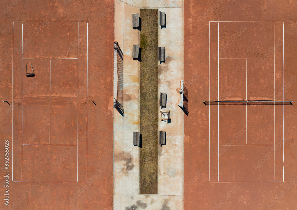 aerial view of two clay tennis courts no people aerial view of two clay tennis courts no people