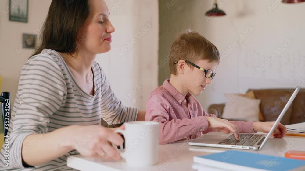 boy son typing on laptop and laughing smiling with mom. Spbas child watching searching funny videos cartoons. young kid leisure time together with mom. concept quarantine, isolated stay home boy son typing on laptop and laughing smiling with mom. Spbas child watching searching funny videos cartoons. young kid leisure time together with mom. concept quarantine, isolated stay home