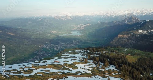 Panoramic aerial view of Lucerne in the natural valley surrounded by lighty snow covered mountains in the mountainious landscape of Switzerland. Swiss Alps in the background. photo