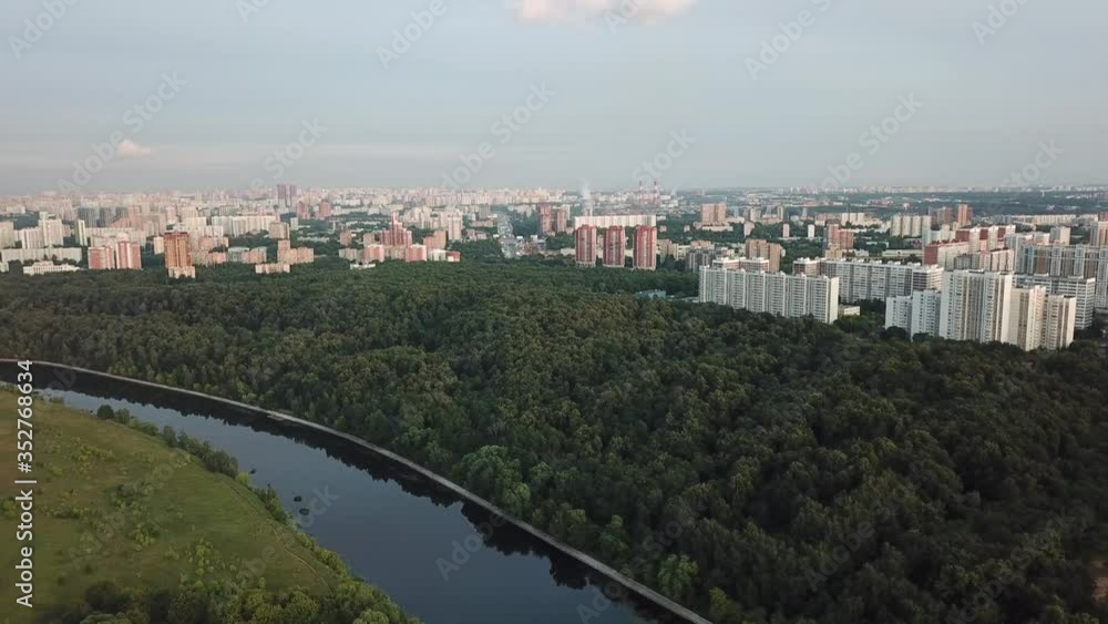 4K quality aerial video scenic view of Grebnoi rowing channel, green park, distant city and hills in Krylatskoye area on cloudy afternoon near Moscow River in Moscow, Russia 4K quality aerial video scenic view of Grebnoi rowing channel, green park, distant city and hills in Krylatskoye area on cloudy afternoon near Moscow River in Moscow, Russia