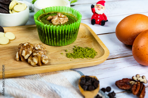 Chocolate Brownie Cake in Paper Cups Decorated with components for making cakes placed on wooden floors