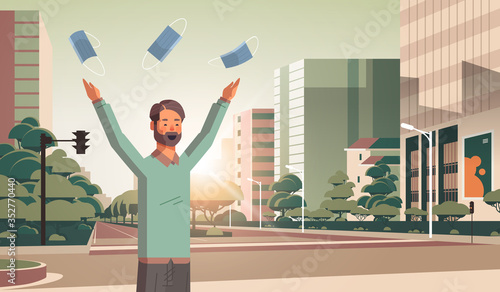 man throwing medical masks coronavirus win defeated covid-19 guy celebrating victory over nCoV virus ending pandemic quarantine concept cityscape background portrait horizontal vector illustration