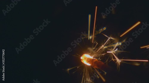 Wallpaper Mural Sparks of Bengal light fly around on a black background. Closeup Torontodigital.ca