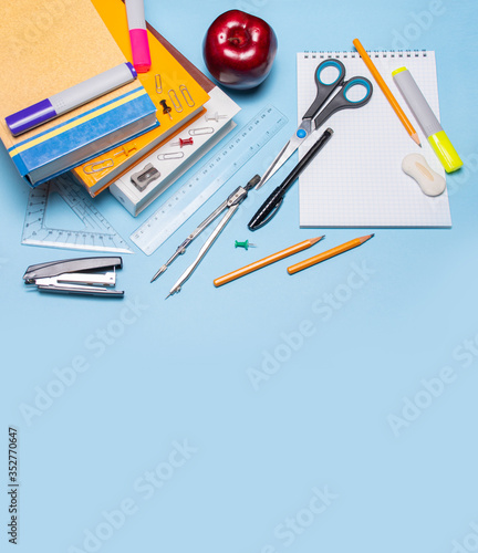 School supplies on a blue background. Back to school! Top view