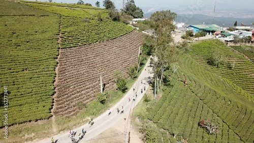 Aerial view of many people started running on the mountain road of Cau Dat farm photo