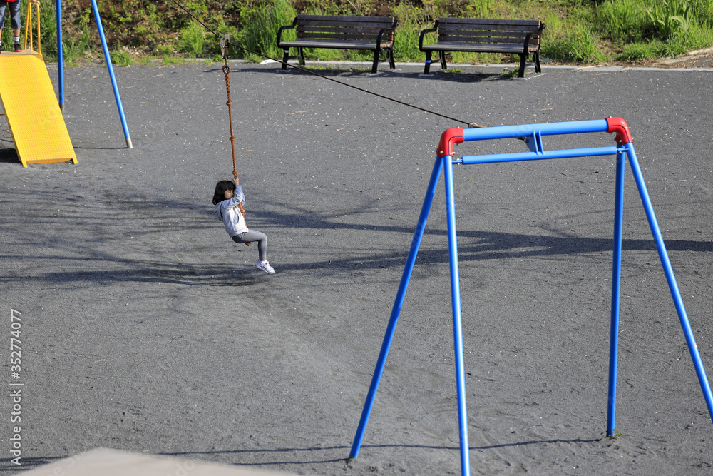 Fototapeta premium ターザンロープで遊ぶ幼児(5歳児)