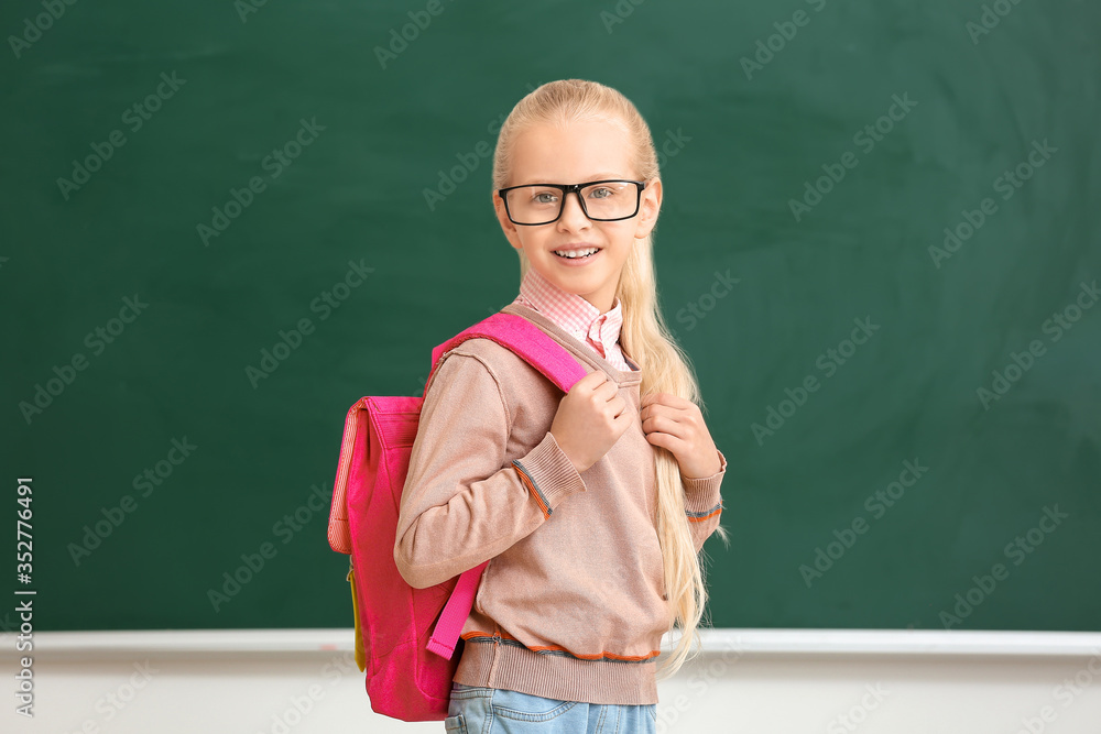 Cute little schoolgirl in classroom Cute little schoolgirl in classroom