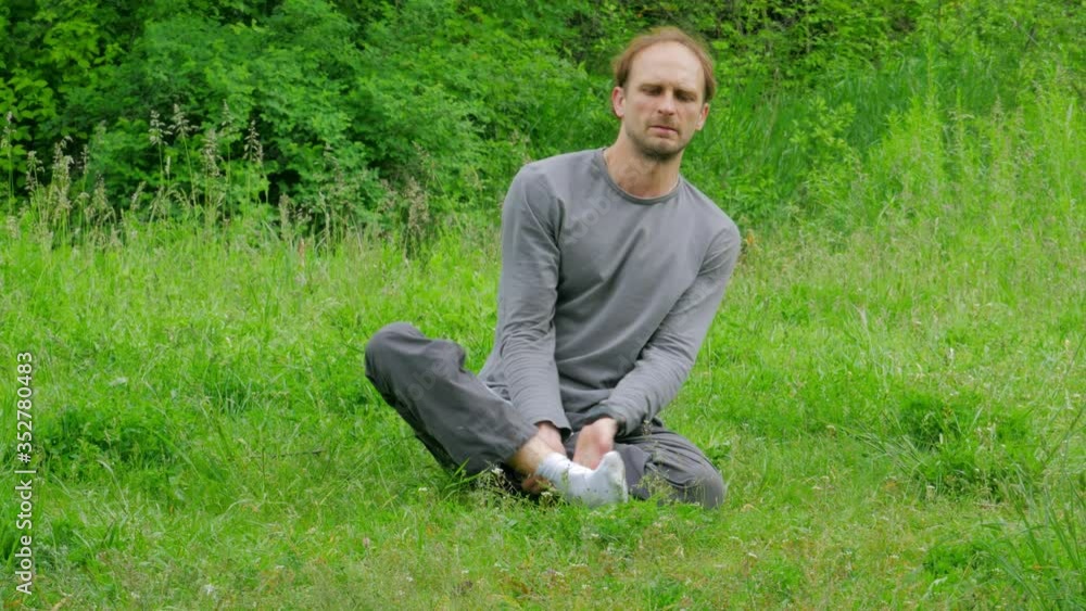 man doing yoga exercises in the forest man doing yoga exercises in the forest