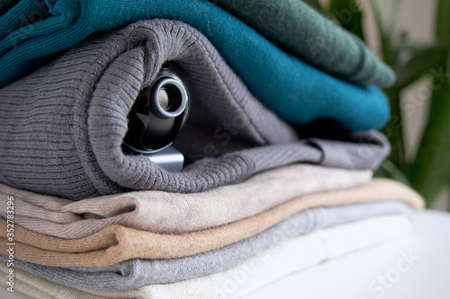 Webcam hidden in a stack of clothes for covert surveillance of the house. Surveillance and security systems. Smart House. Espionage. Hidden camera for watching