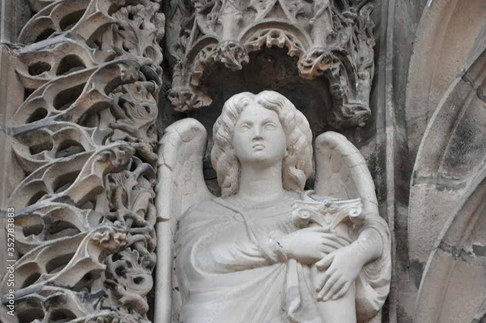 ALBI, FRANCE, EUROPE, SPRING 2019. Angel statue at the entrance of the Cathedral Basilica of Saint Cecilia or the Catholic Basilica of Saint Cécile of red brick is a Gothic masterpiece