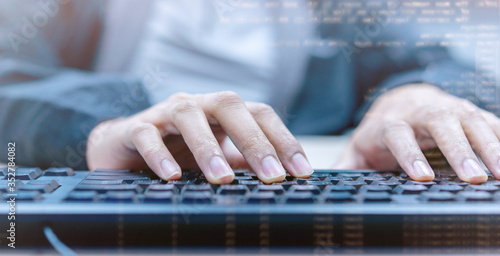 close up programmer man hand typing on keyboard at desktop pc to input code language into software for study bug and defect of system at office for development of technology concept 