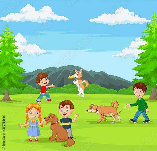 Group of children playing with their dogs in the park