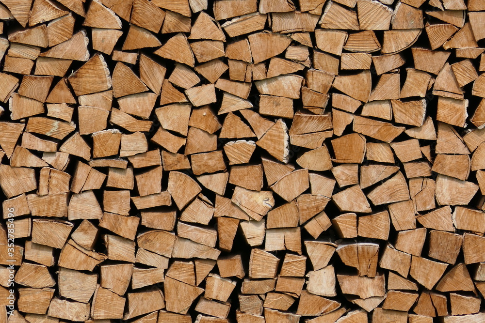 Neatly stacked pile of firewood, wooden structure Neatly stacked pile of firewood, wooden structure