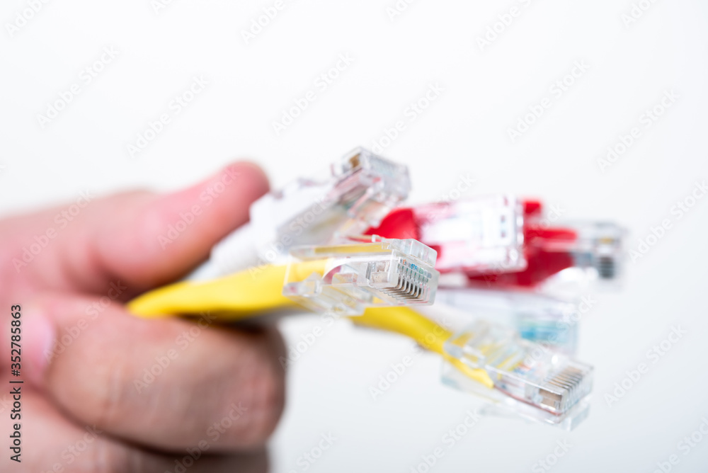 man hand holding Ethernet cables on white background man hand holding Ethernet cables on white background