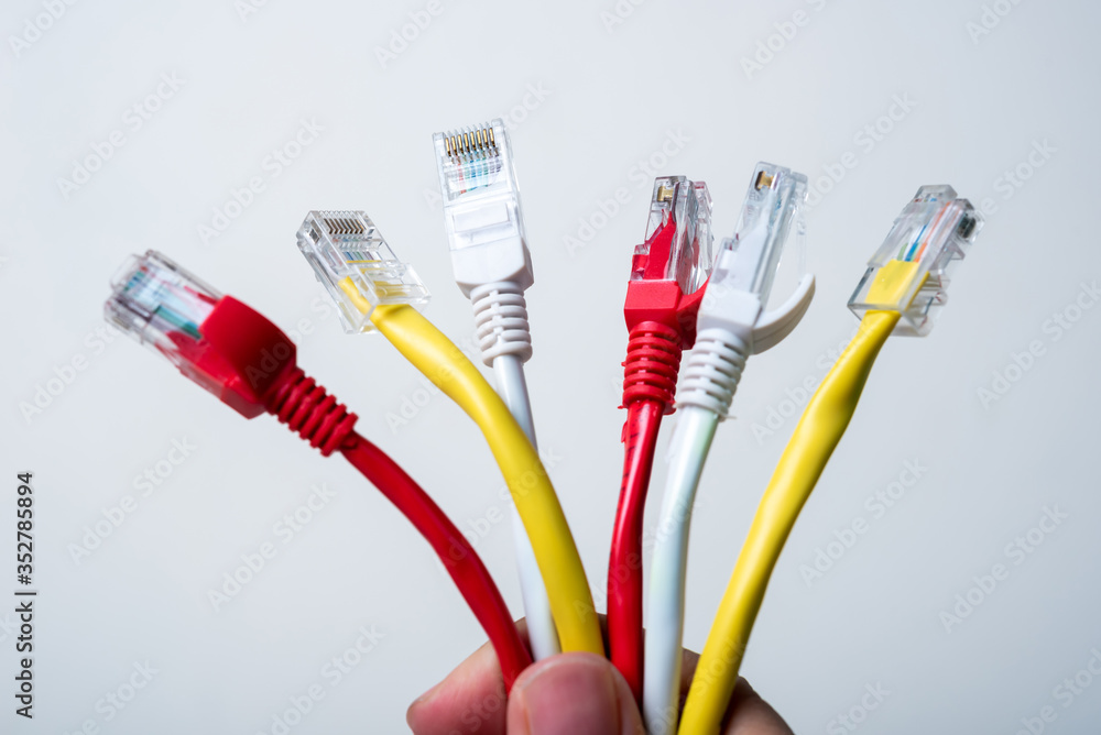 man hand holding Ethernet cables on white background man hand holding Ethernet cables on white background