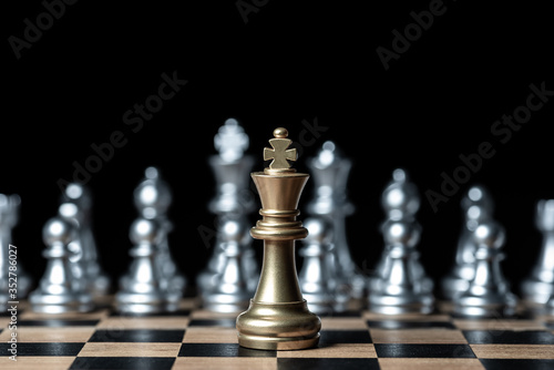 gold against silver chess pieces team on chess board  business strategy concept