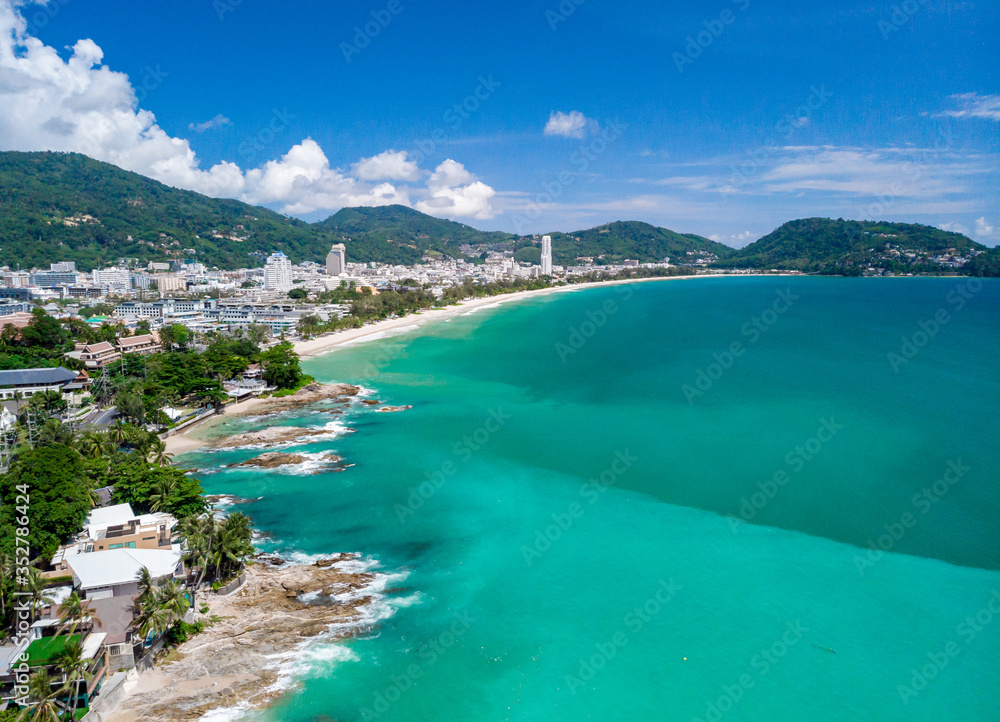 Aerial view of quiet beautiful sunny day Patong beach in Phuket Thailand during locked down policy due to Covid-19. All beaches in Phuket are not allowed to enter.