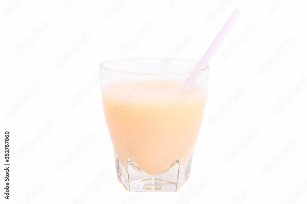 Banana juice in a glass with cocktail tube Banana juice in a glass with cocktail tube