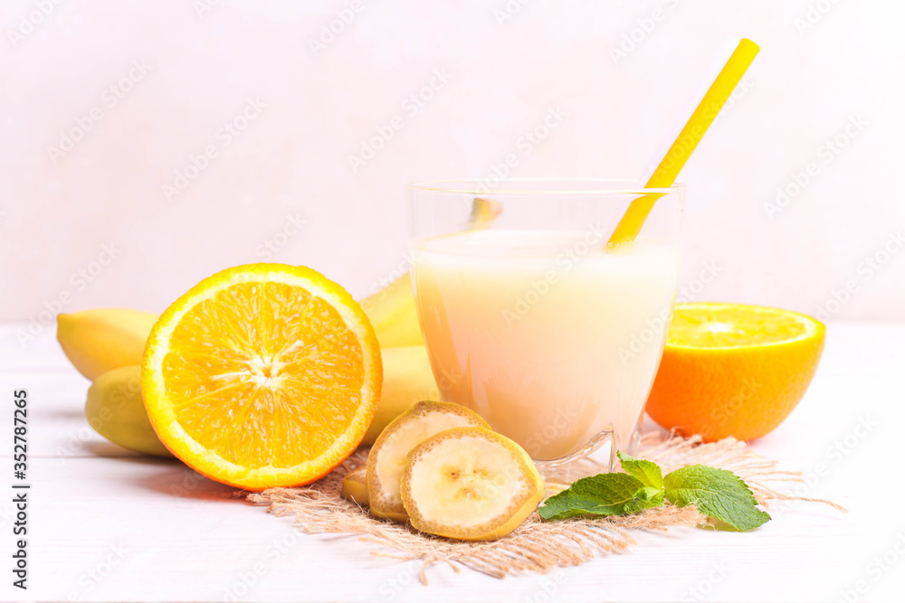 Fototapeta premium Banana juice in a glass with fruits
