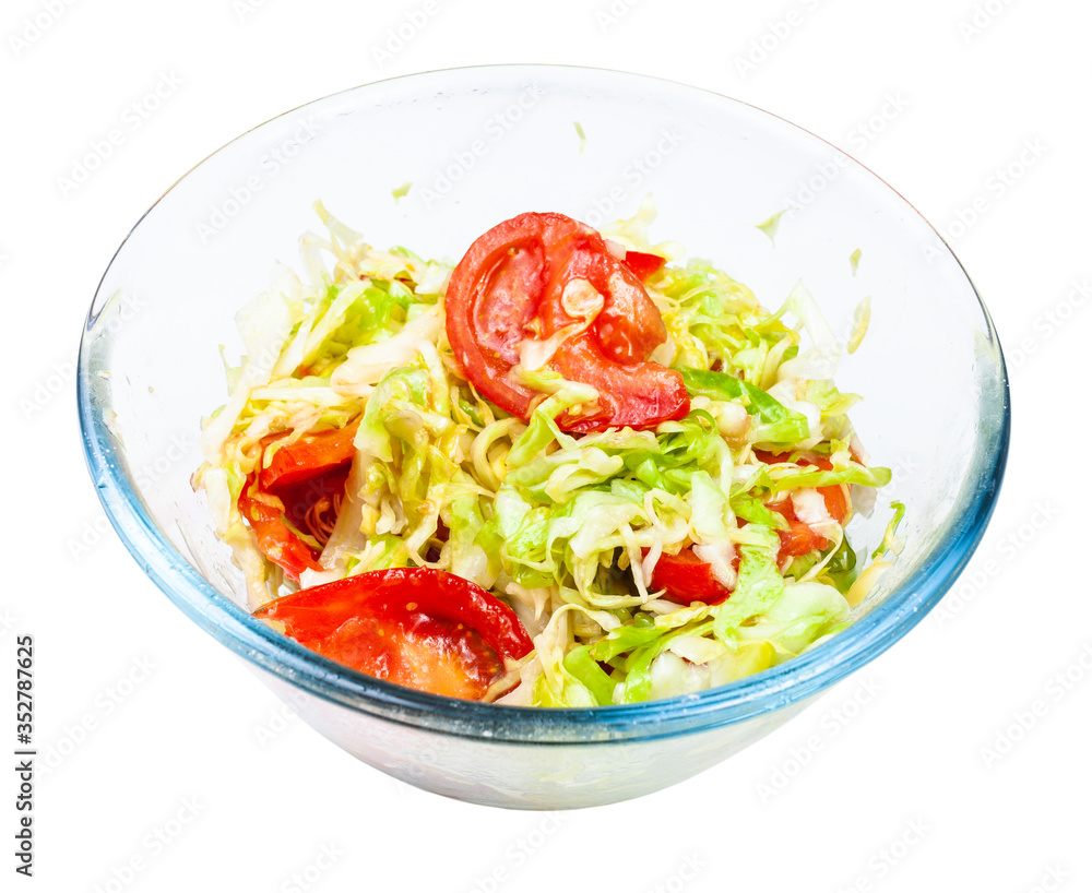 vegetable salad from fresh chopped tomatoes and shredded cabbage in glass bowl isolated on white background vegetable salad from fresh chopped tomatoes and shredded cabbage in glass bowl isolated on white background
