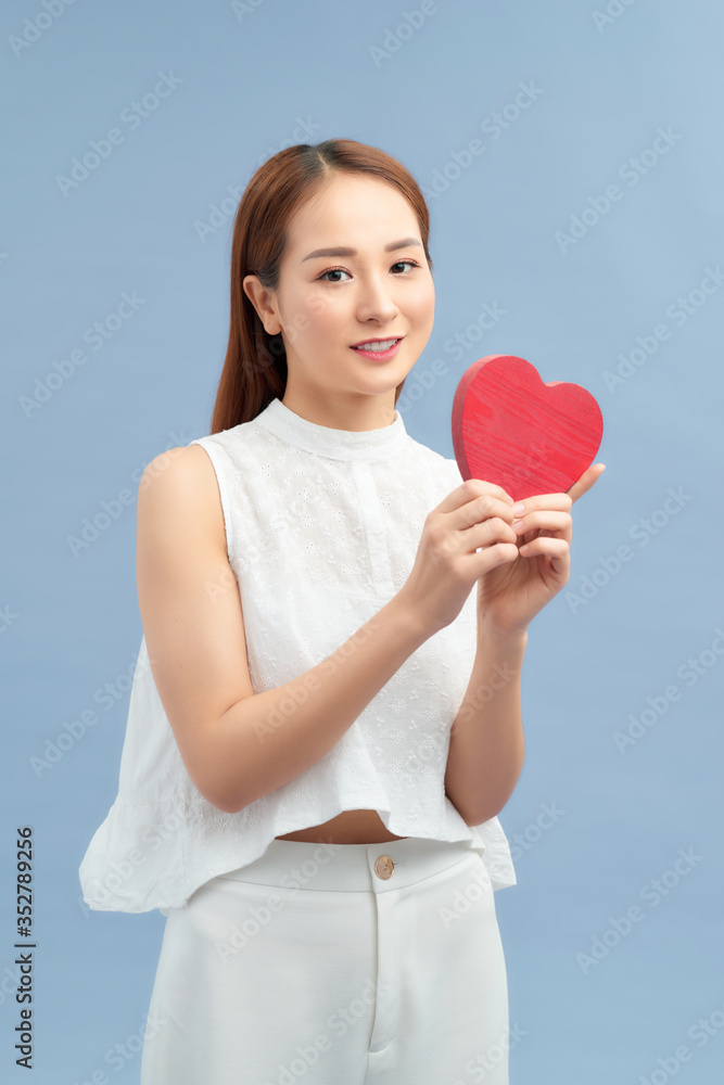 young happy woman hold heart . valentine day concept . young happy woman hold heart . valentine day concept .