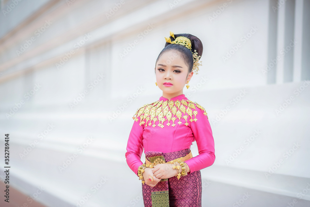 Portrait smiling Asia Girl in Thai Traditional Antique Dress of Old Kingdom in Siam, Southeast Asia. Portrait smiling Asia Girl in Thai Traditional Antique Dress of Old Kingdom in Siam, Southeast Asia.