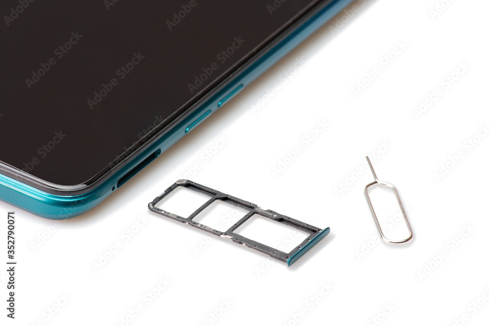 Sim card tools, Small nano sim card, and Micro SD card tray with smartphones isolated on white background. Selective focus. Sim card tools, Small nano sim card, and Micro SD card tray with smartphones isolated on white background. Selective focus.