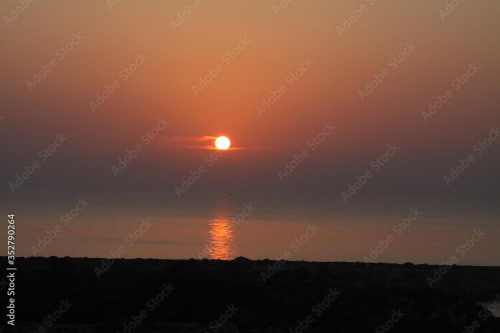 Orange beautiful sunrise on the sea. Relax vacation. Meet the sunrise on the seashore. Romantic coasline. Wallpaper and background.