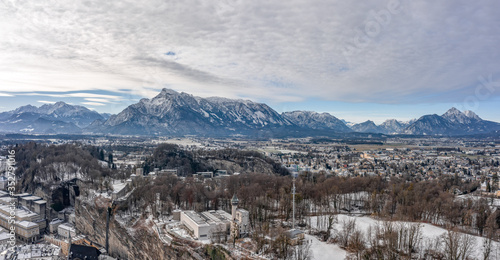 Panoramic aerial view of Mochsberg top with view of Untersberg snow mountain in Salzburg winter