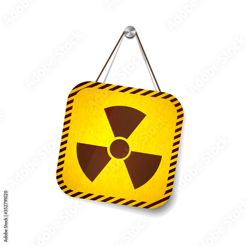 Radiation grunge warning sign hanging on the rope on white