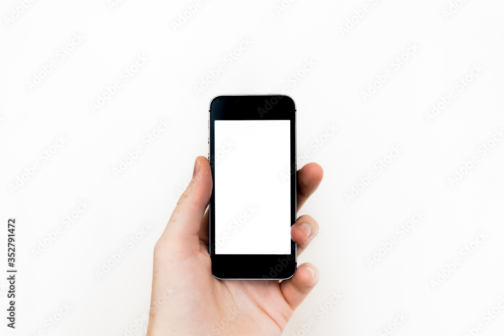 smartphone with white screen in the left hand. layout for designers. smartphone with white screen in the left hand. layout for designers.