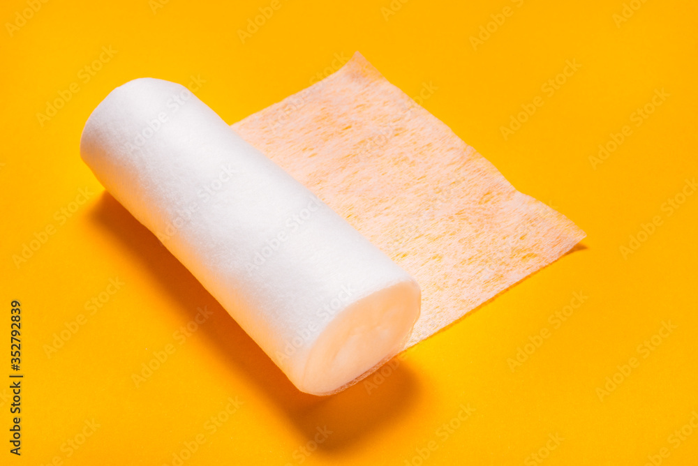 Fototapeta premium Tape medical bandage roll on color background, medicine equipment for first aid