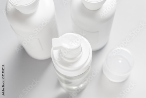 Plastic bottle dispenser top view on grey background