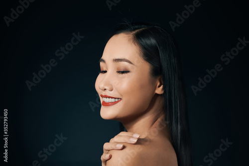 Portrait of attractive Asian woman isolated over balck background