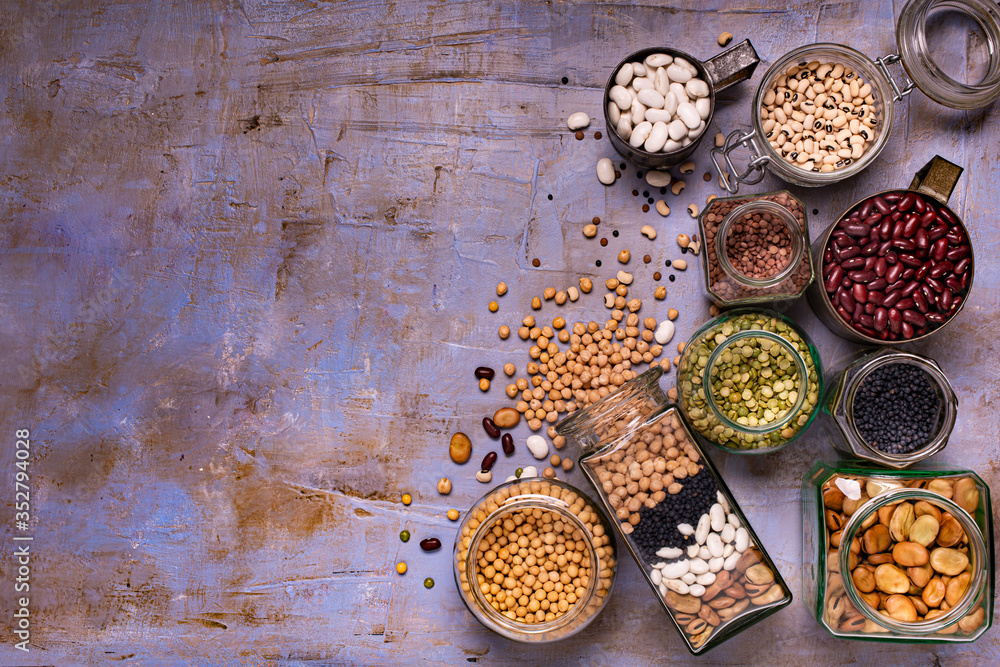 large variety of dried legumes in glass jars. background texture with top view large variety of dried legumes in glass jars. background texture with top view
