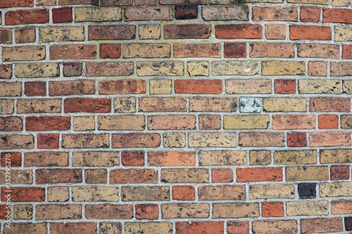 Old brick wall with many different colors of bricks as a background 