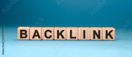 Backlink - text concept on wooden cubes with blue background