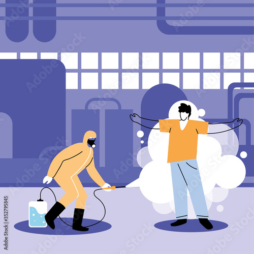 man in suit disinfecting human in industry