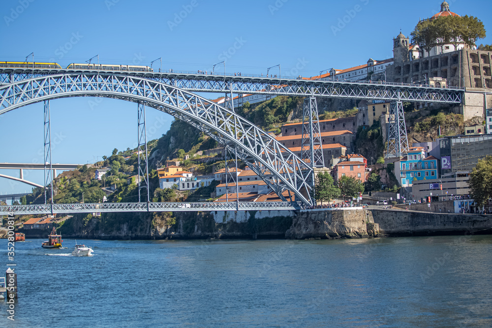 View of D. Luis bridge and Douro river, Porto city downtown as background