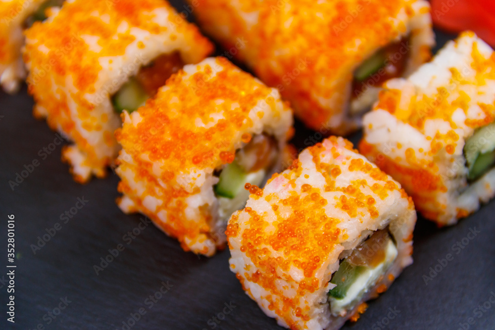 Sushi rolls Philadelphia on a black slate Sushi rolls Philadelphia on a black slate